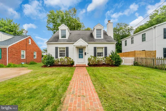 a front view of a house with yard patio and green space