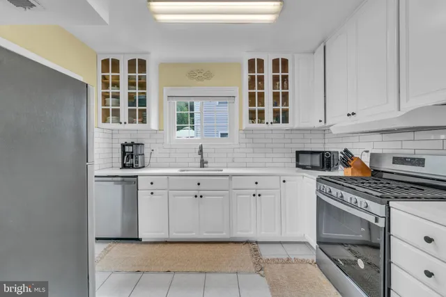 a kitchen with stainless steel appliances granite countertop a stove and cabinets