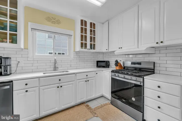 a kitchen with cabinets appliances and a sink
