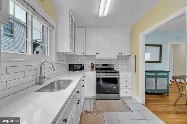a kitchen with stainless steel appliances granite countertop a sink and cabinets