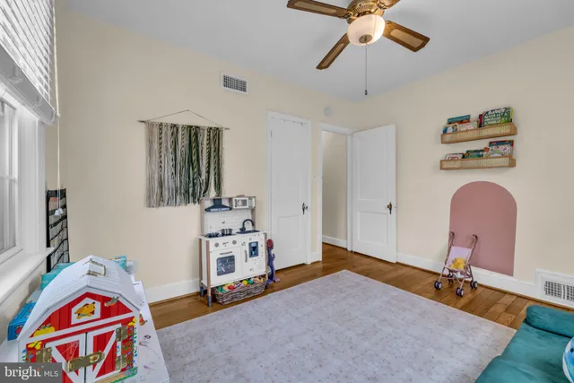 a bedroom with bed and a chandelier