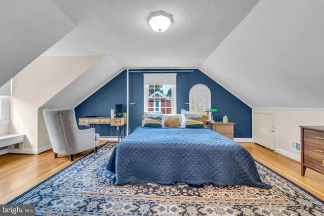 a bedroom with a large bed and a dresser