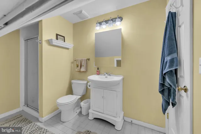 a bathroom with a toilet sink and a mirror