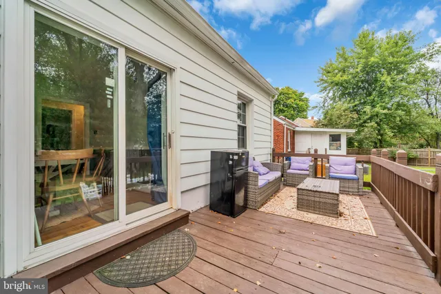 a view of a wooden deck and a yard with swimming pool