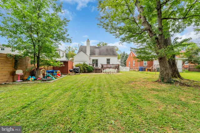 a view of swimming pool with a garden and trees
