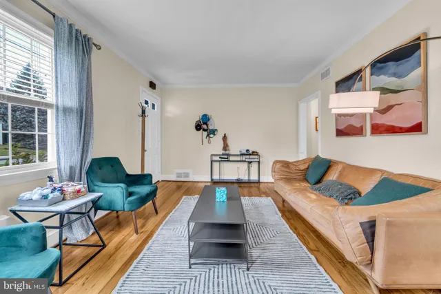 a living room with furniture rug and window