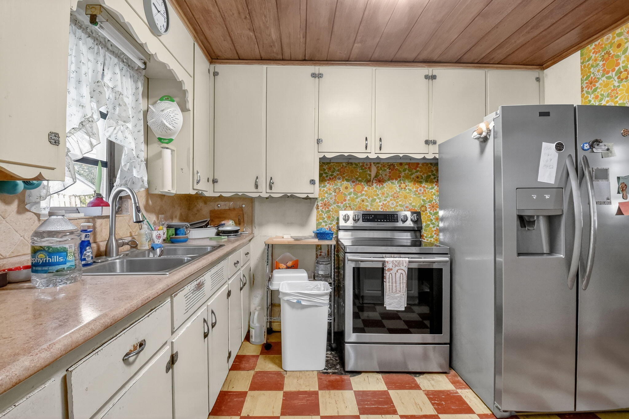 3582 Davis Road Palm Springs, FL 33461 - Photo 13 of 42 a kitchen with stainless steel appliances a refrigerator sink and cabinets