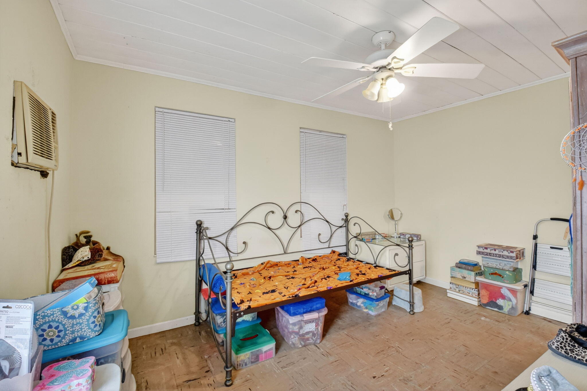 3582 Davis Road Palm Springs, FL 33461 - Photo 19 of 42 a bedroom with a bed and a chandelier