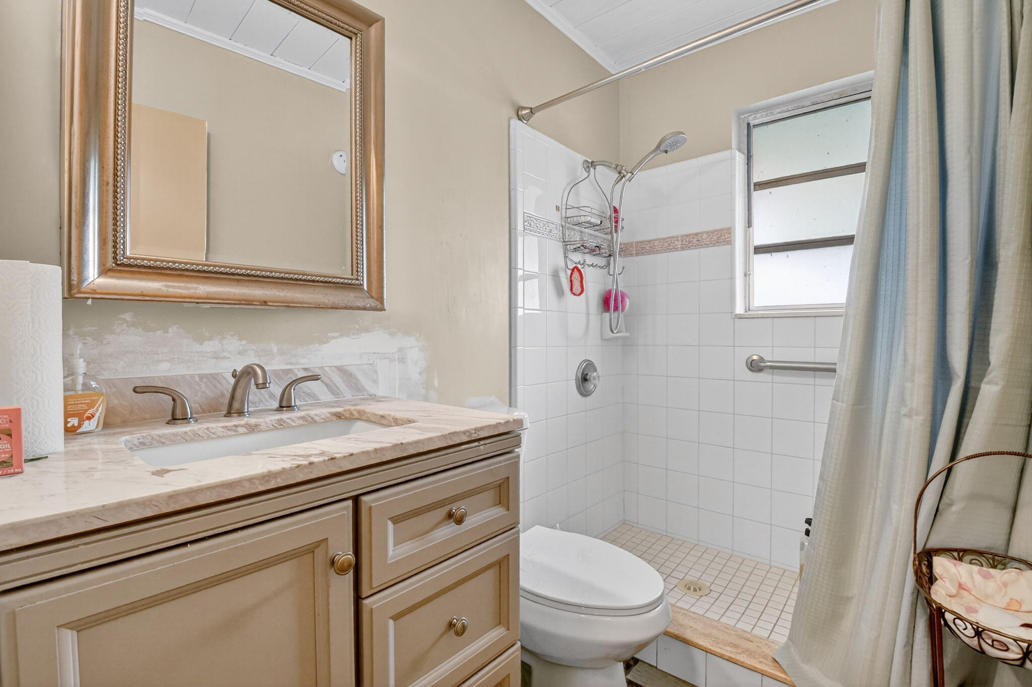 3582 Davis Road Palm Springs, FL 33461 - Photo 23 of 42 a bathroom with a granite countertop sink toilet and shower