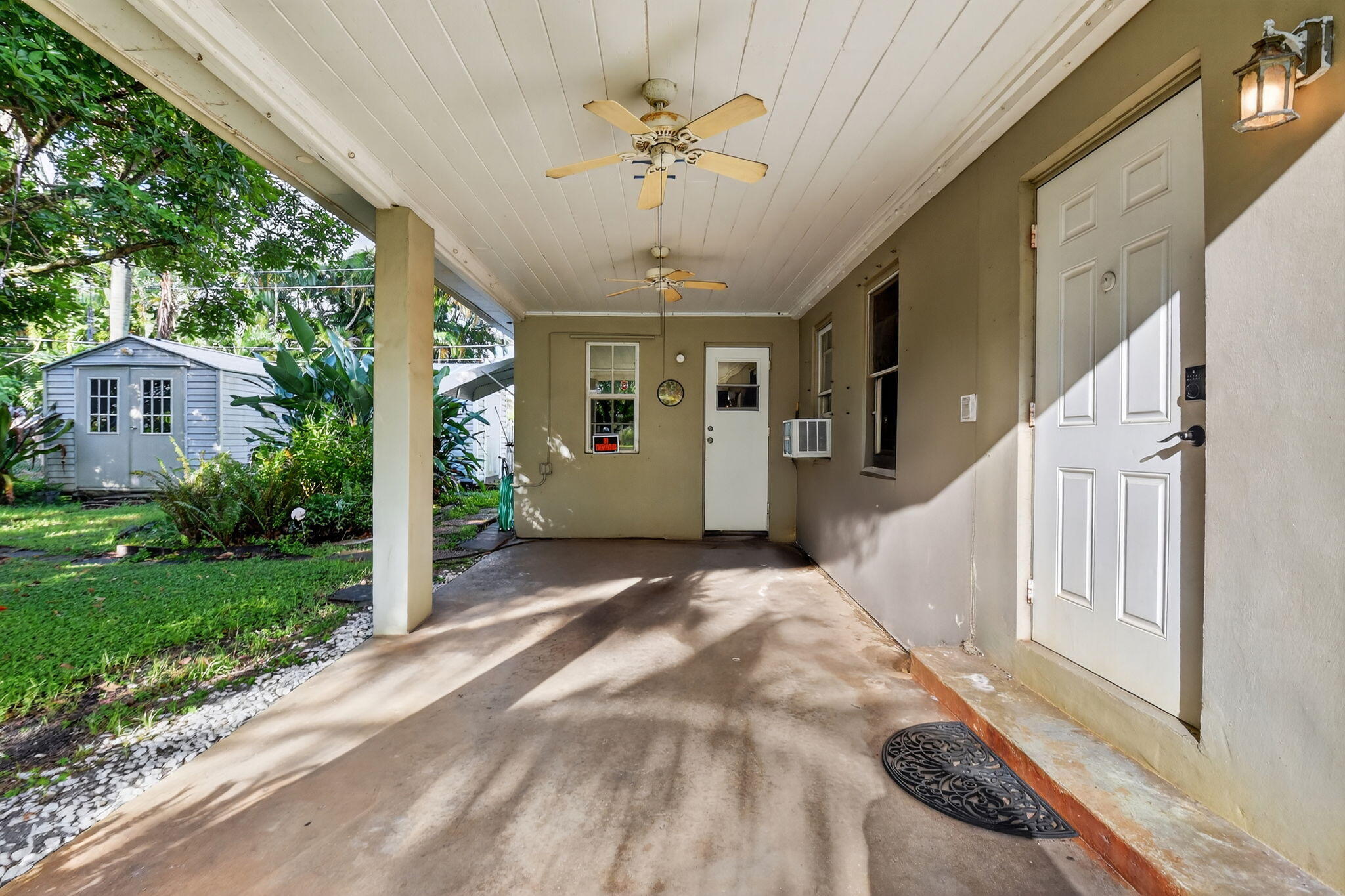 3582 Davis Road Palm Springs, FL 33461 - Photo 3 of 42 a view of a porch with a table and chairs