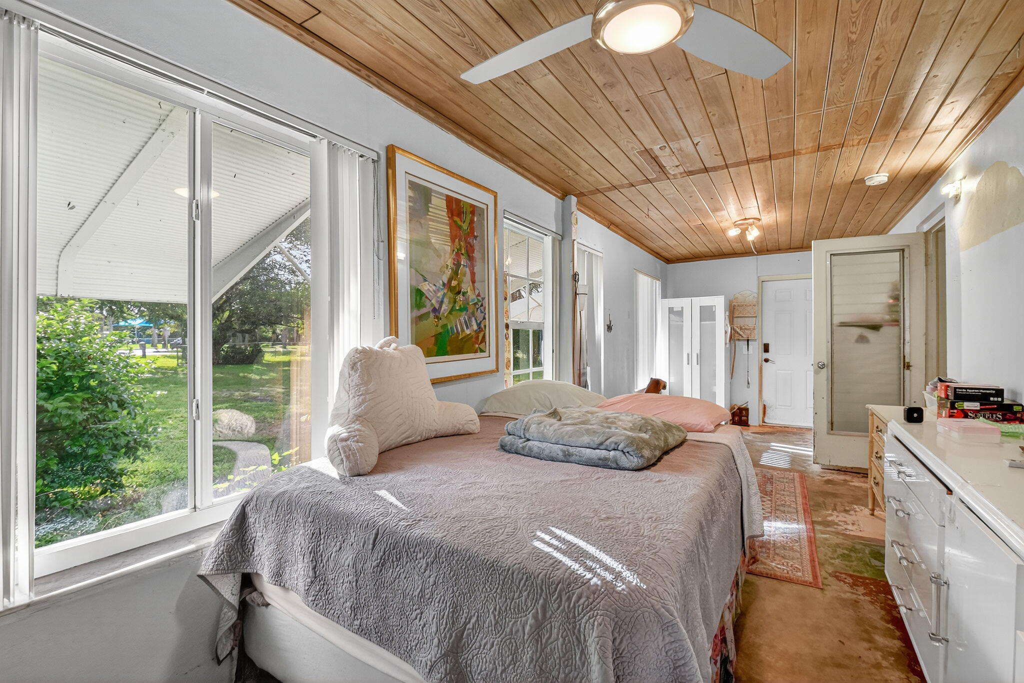 3582 Davis Road Palm Springs, FL 33461 - Photo 6 of 42 a bedroom with a large bed and a large window