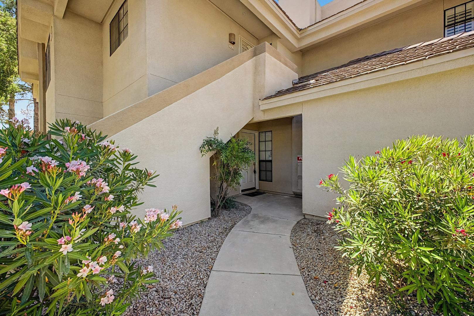 6885 East Cochise Road, Unit 142 Paradise Valley, AZ 85253 - Photo 3 of 47 a view of a pathway with a white house next to a yard