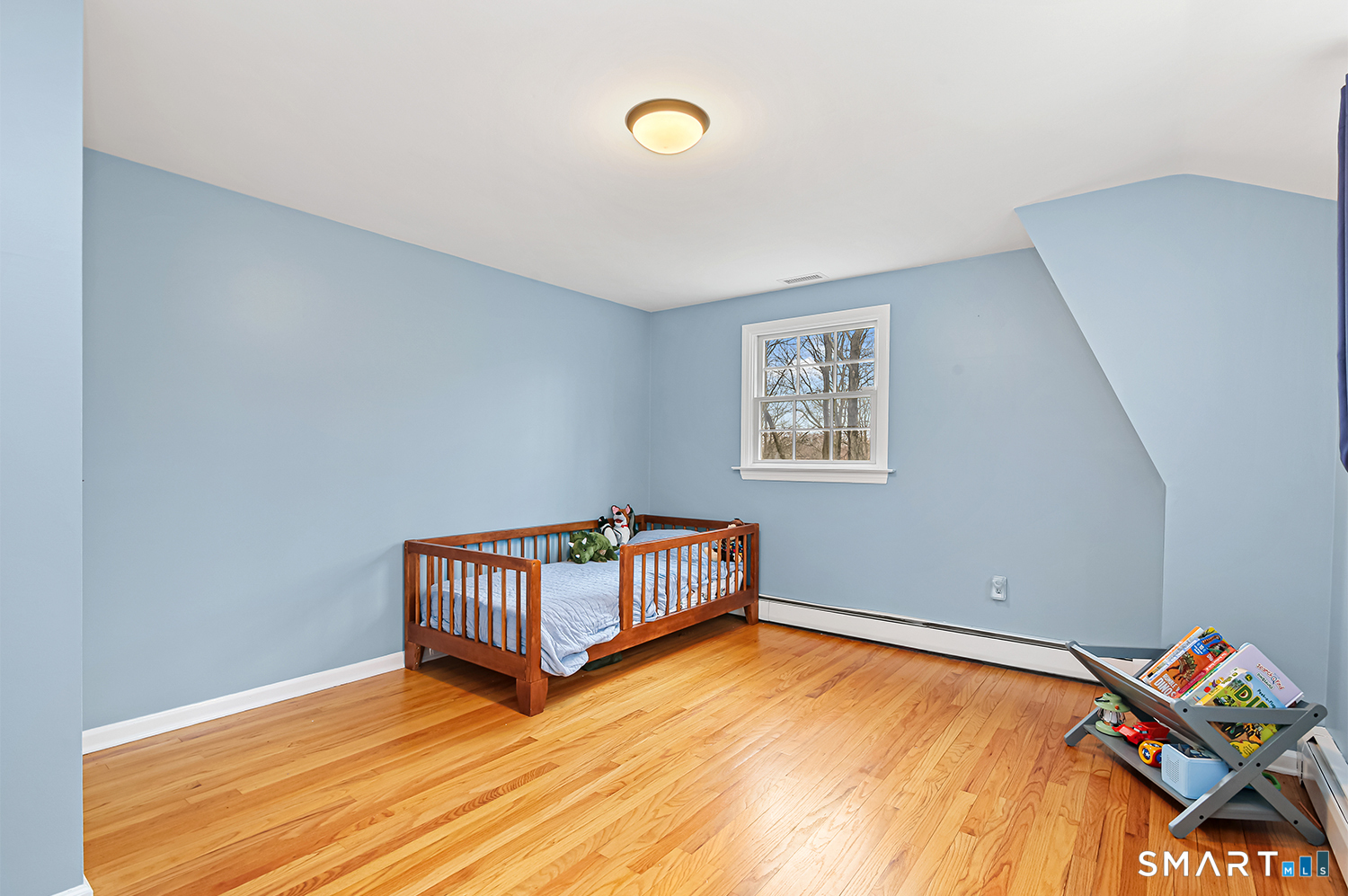 99 Chicken Street Wilton, CT 06897 - Photo 27 of 38 a room with a bed and wooden floor