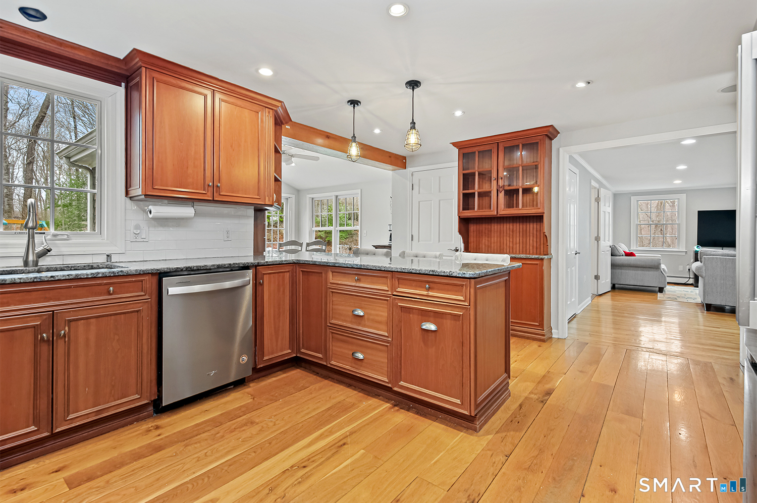 99 Chicken Street Wilton, CT 06897 - Photo 7 of 38 a kitchen with stainless steel appliances granite countertop a sink a stove cabinets counter space and a large window