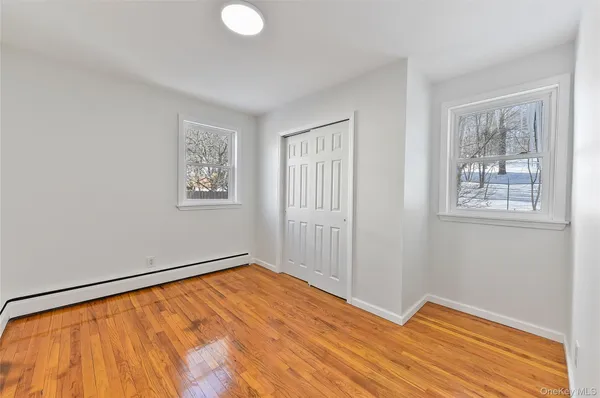 a view of a room with wooden floor and entryway