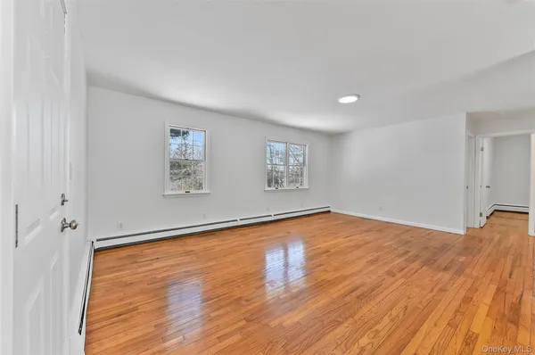 a big room with wooden floor and natural light