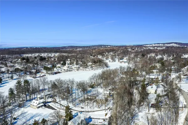 a view of a house with a yard covered in snow
