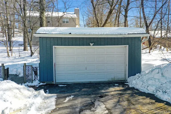a front view of a house with a yard covered in snow