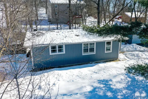 a view of house with backyard of house