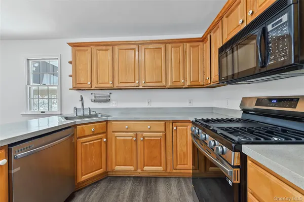 a kitchen with stainless steel appliances granite countertop a refrigerator and a stove top oven