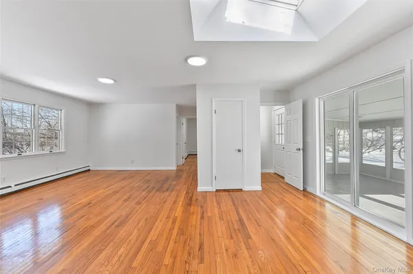 a view of empty room with wooden floor