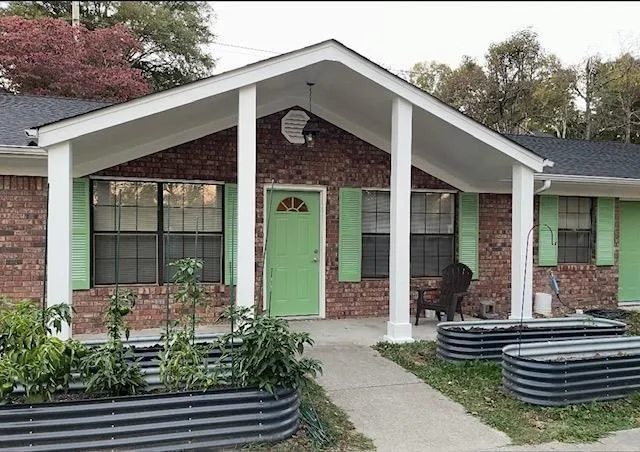 a front view of a house with garden