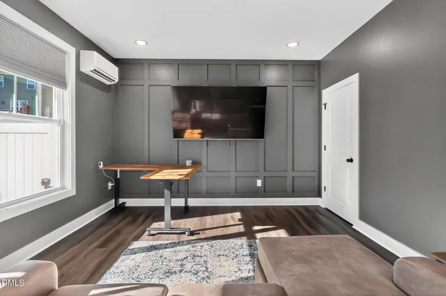 a living room with a flat screen tv and outdoor seating