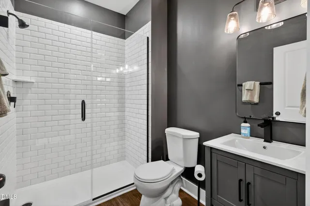 a bathroom with a sink toilet and shower