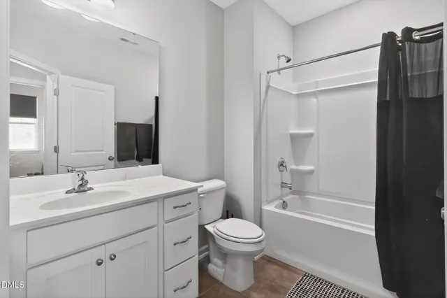 a bathroom with a sink toilet and a mirror