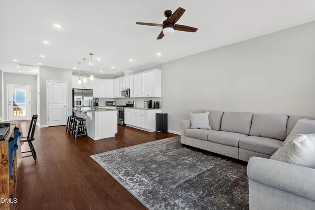 a living room with furniture and kitchen view