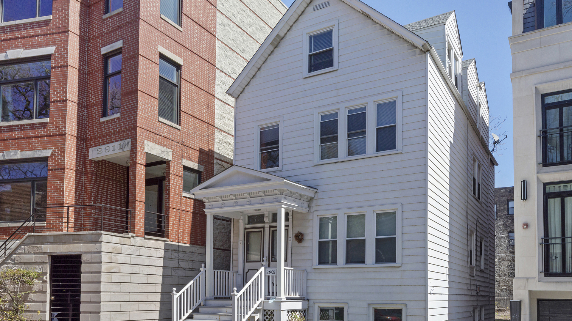 2905 North Burling Street, Unit 2 Chicago, IL 60657 - Photo 1 of 17 a front view of a building with a yard