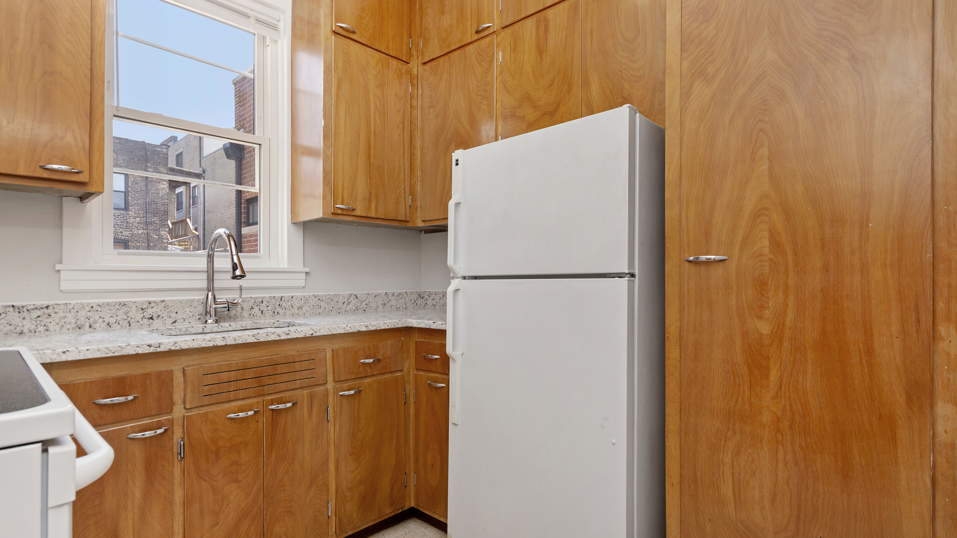 2905 North Burling Street, Unit 2 Chicago, IL 60657 - Photo 11 of 17 a kitchen with a refrigerator and a sink