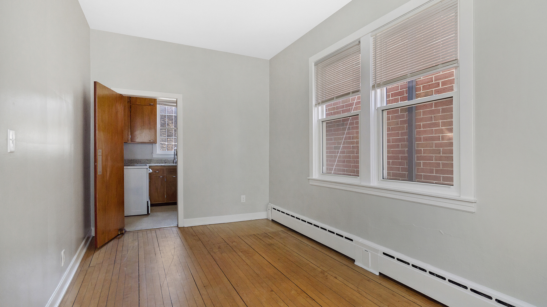2905 North Burling Street, Unit 2 Chicago, IL 60657 - Photo 15 of 17 a view of an empty room with wooden floor and a window