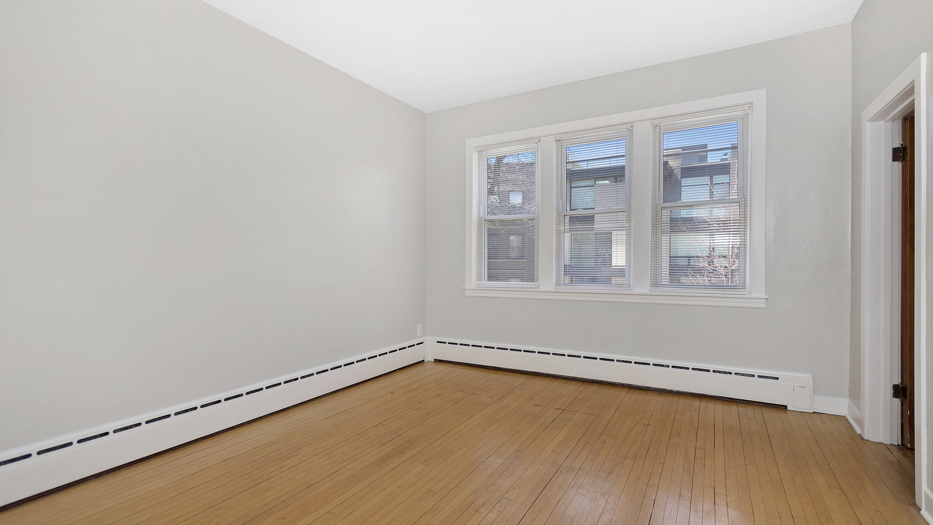 2905 North Burling Street, Unit 2 Chicago, IL 60657 - Photo 3 of 17 a view of a room with wooden floor and windows