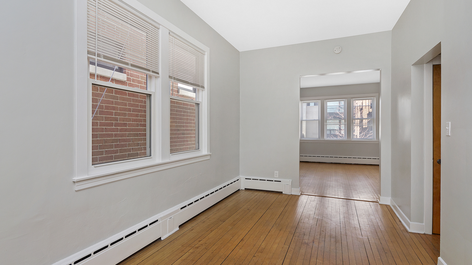 2905 North Burling Street, Unit 2 Chicago, IL 60657 - Photo 8 of 17 a view of an empty room with wooden floor and a window