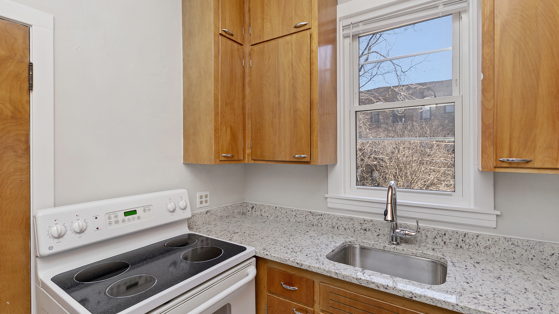 2905 North Burling Street, Unit 2 Chicago, IL 60657 - Photo 9 of 17 a kitchen with a sink cabinets and a window