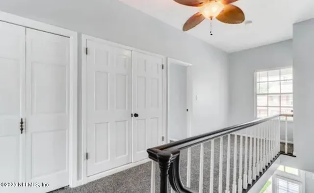 a view of entryway and chandelier fan