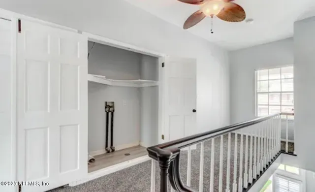 a view of staircase with railing and a chandelier