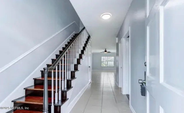 a view of a hallway with wooden floor and entryway