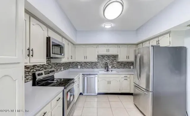 a kitchen with a stove a sink and a refrigerator