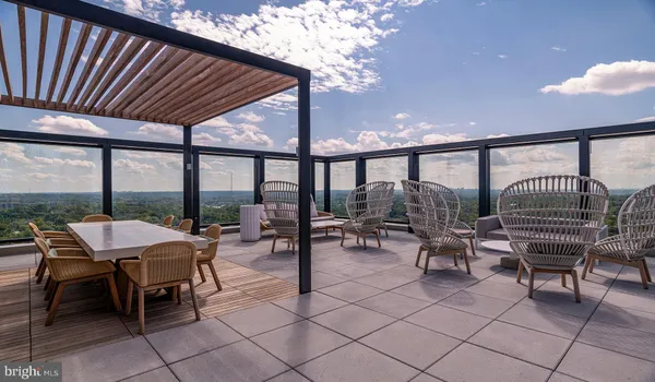 a view of a balcony with two chairs and a barbeque
