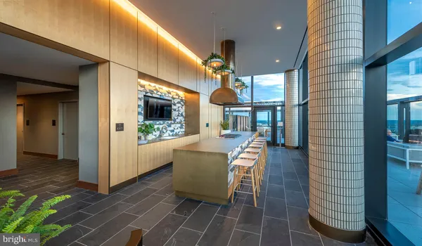 a view of a balcony with wooden floor and outdoor seating