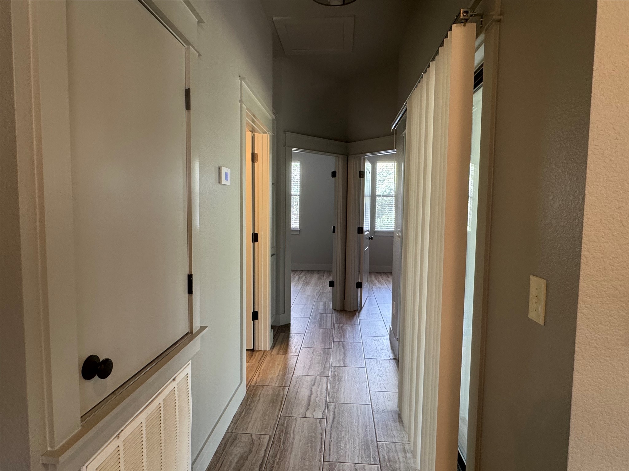 290 Hugo Road, Unit B San Marcos, TX 78666 - Photo 11 of 22 a view of a hallway with wooden floor and a bathroom