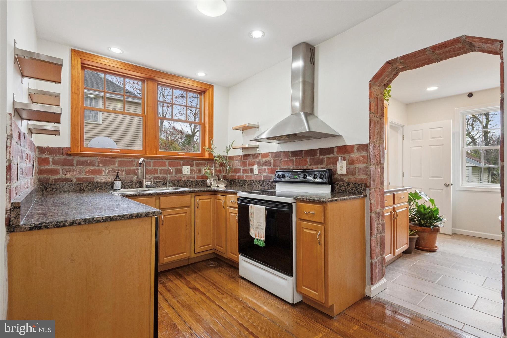 228 Avon Road Narberth, PA 19072 - Photo 11 of 24 a kitchen with stainless steel appliances granite countertop a stove a sink and a microwave