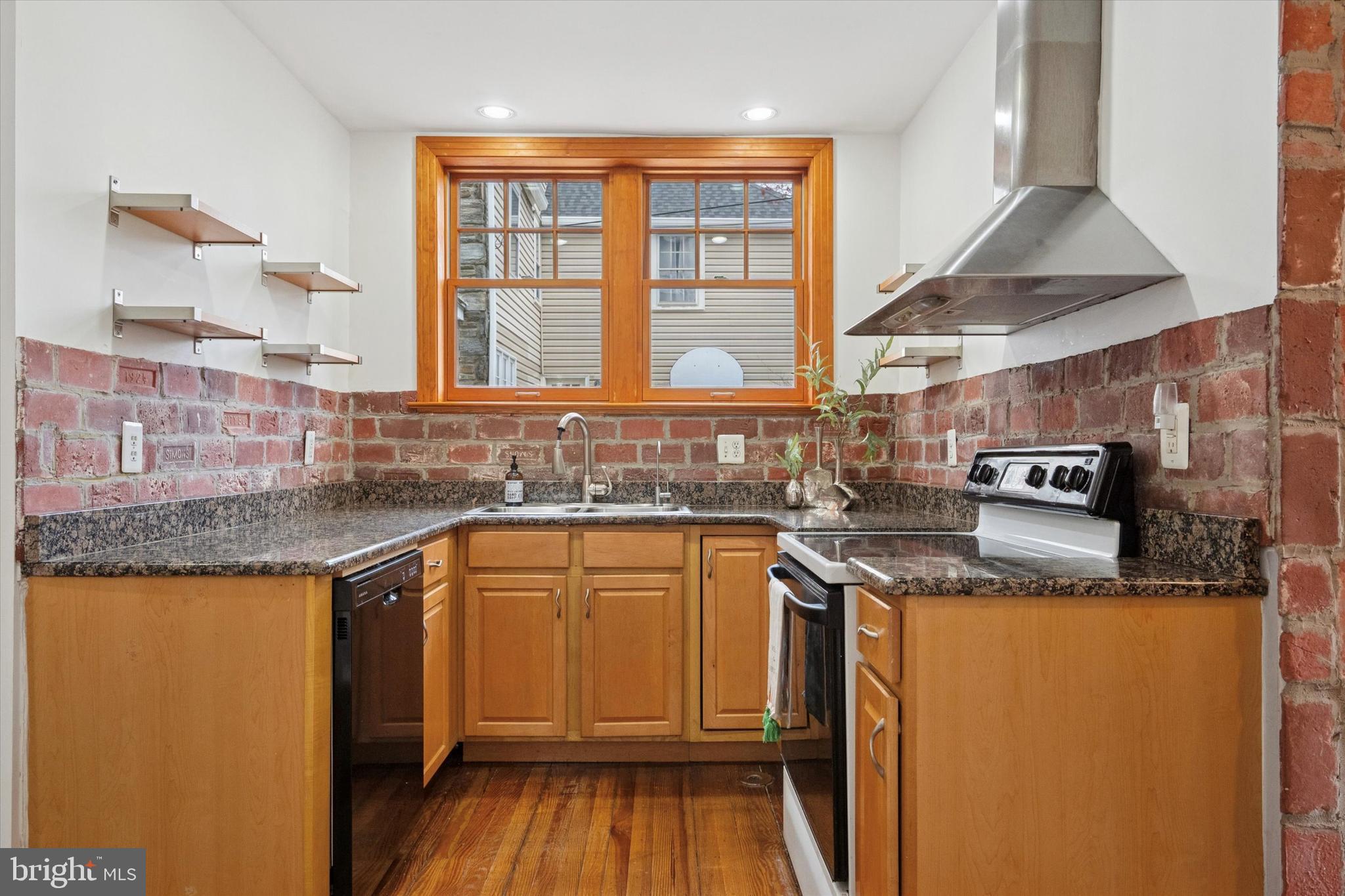 228 Avon Road Narberth, PA 19072 - Photo 12 of 24 a kitchen with stainless steel appliances granite countertop a sink stove and cabinets