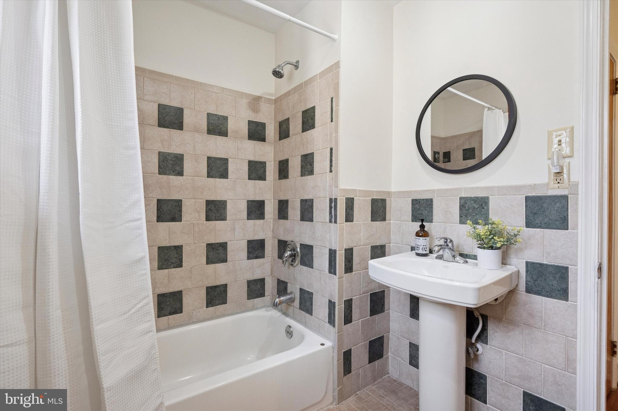 228 Avon Road Narberth, PA 19072 - Photo 18 of 24 a bathroom with a sink and a mirror