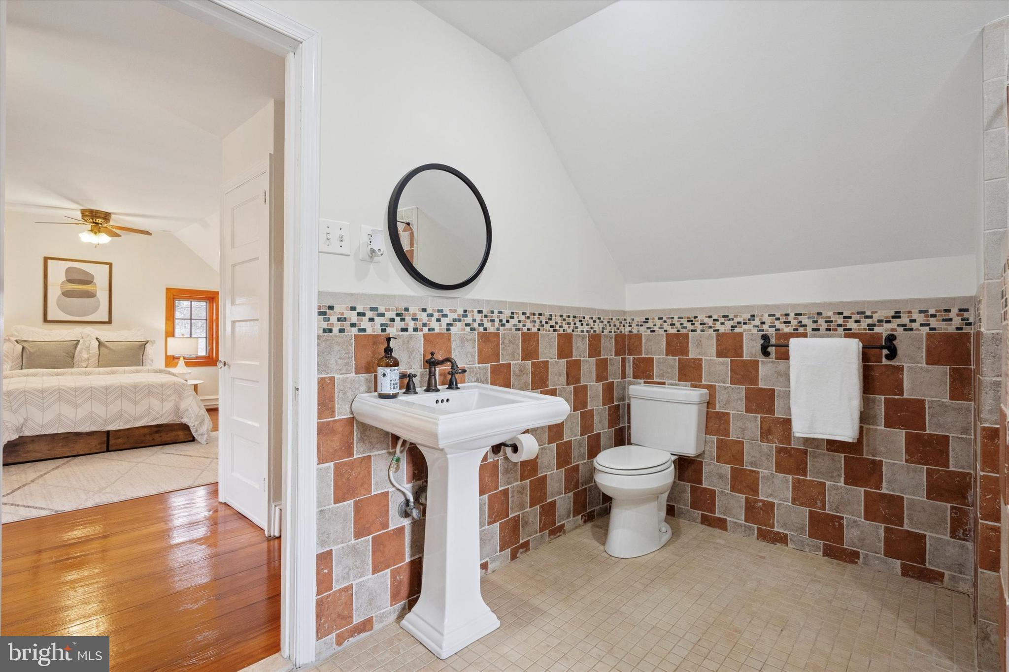 228 Avon Road Narberth, PA 19072 - Photo 20 of 24 a bathroom with a sink a toilet and a mirror