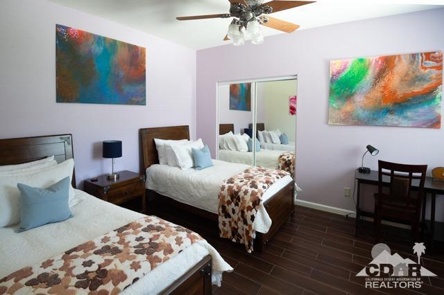82320 Lancaster Way Indio, CA 92201 - Photo 13 of 27 a bedroom with a bed and wooden floor