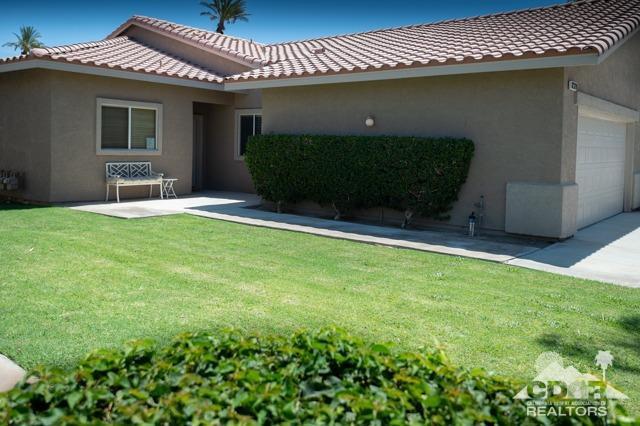 82320 Lancaster Way Indio, CA 92201 - Photo 15 of 27 a front view of a house with garden