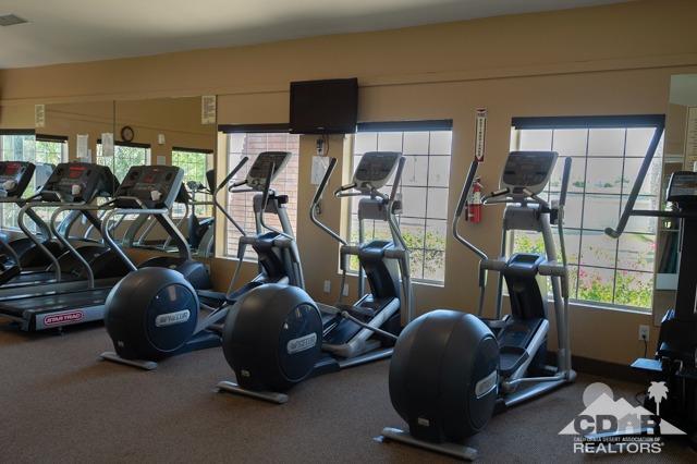82320 Lancaster Way Indio, CA 92201 - Photo 22 of 27 a room with gym equipment and mirror